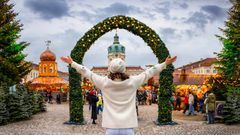 Frau vor einem Weihnachtsmarkt in Berlin