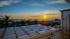 Hotel Mandetta, Blick auf den Strand bei Sonnenuntergang